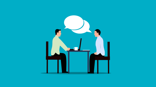 an illustration showing two people sitting either side of a table with speech bubbles between them, and a laptop on the tabletop against a blue background, to represent a workplace conversation