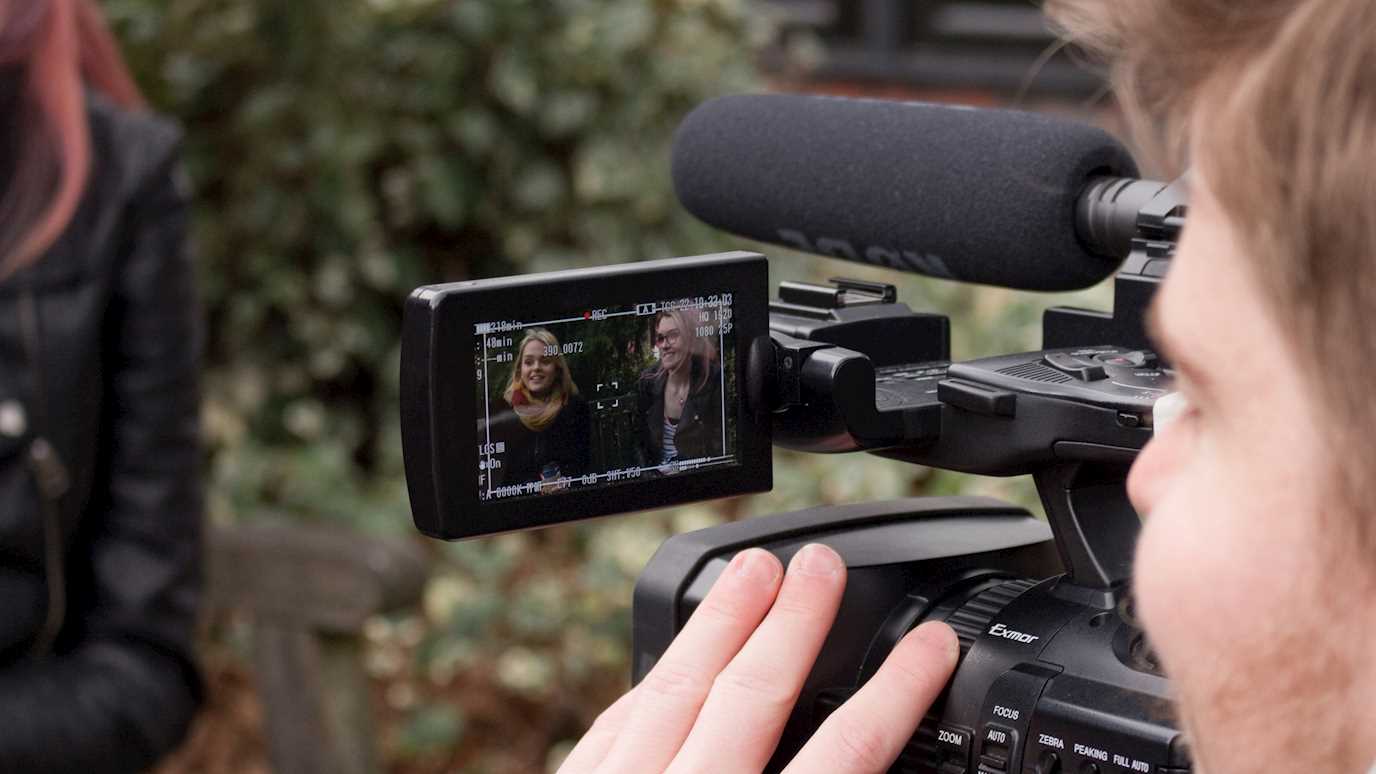 Close up of student using a camera - Media Arts